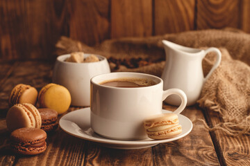 cup of coffee, milk, sugar and  macaroons   on wooden background