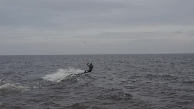 Athletes ride kite surfin. Kiev sea. Summer. Windy weather. Competition. Colored sails. Aerial. Ukraine. Kyiv. 