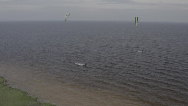 Athletes ride kite surfin. Kiev sea. Summer. Windy weather. Competition. Colored sails. Aerial. Ukraine. Kyiv. 