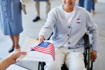 High angle close up of woman with disability receiving voting ballot on election day, copy space