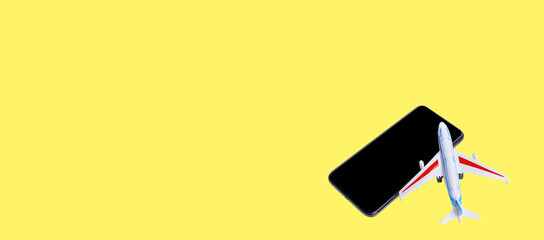 phone and plane on yellow background. Fly now, pay later.  Best time to buy airline tickets online.