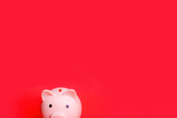 Pink piggy bank isolated against red background Savings and loan crisis Saving money is the key to financial independence