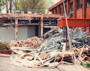 Ruins of a demolished building. Dismantling an old building. Pile of rubble at demolishing site