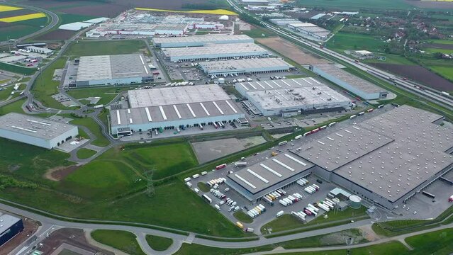 Aerial view of many logistics warehouses in industrial areas, loading and unloading goods for online store, online delivery