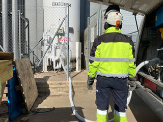 Unrecognizable technician fill with liquid nitrogen with Nitrogen storage tank at new factory