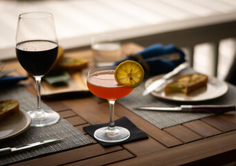 Red Devil Battery vodka cocktail in a dinner setting with unfocused background