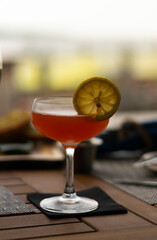 Red Devil Battery vodka cocktail in a dinner setting with unfocused background