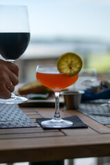 Red Devil Battery vodka cocktail in a dinner setting with unfocused background