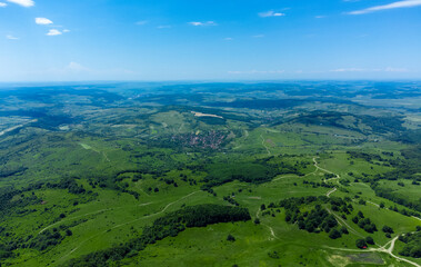 Fototapeta na wymiar Aerial landscape with fields and forests in Transylvania in summer