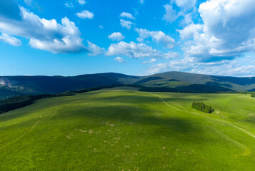 landscape with shadows of clouds on a mountain plain
