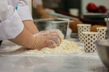 A gastronomy student making dough for Apple Pie. 
