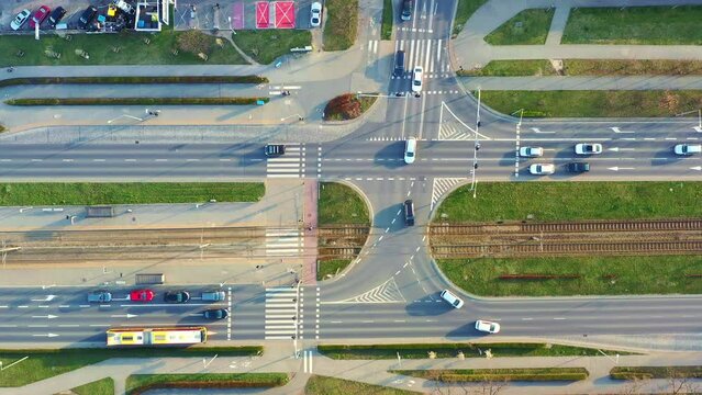 Aerial view of the highway and tram tracks on the city street, urban infrastructure, passing car at the crossroads. Wroclaw, Poland