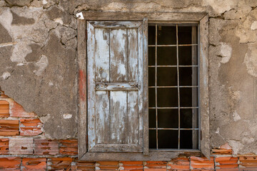 Fototapeta na wymiar Window and iron window bars of an old house