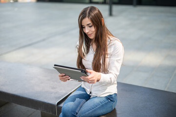 Businesswoman using a digital tablet outdoor