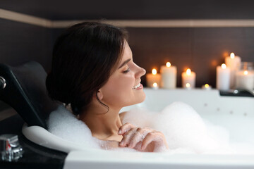 Obraz na płótnie Canvas Happy beautiful woman taking bubble bath. Romantic atmosphere