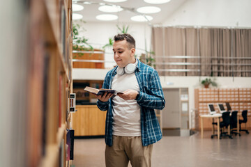 Reads books in the library male student college education uses