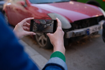 Female insurance broker making photos of car after accident on modern smartphone - obrazy, fototapety, plakaty