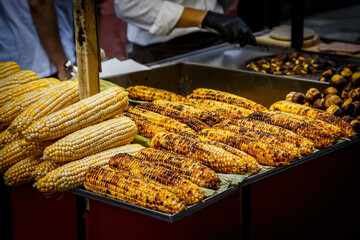 Fried grilled corn at a street food market kiosk.