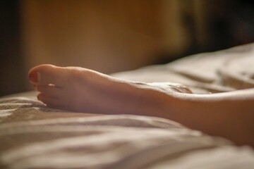 Obraz na płótnie Canvas feet in bed