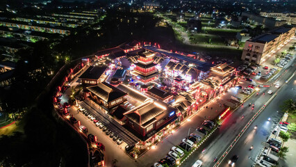 Aerial view of Shanghai old town street decorated with red chinese lanterns at night. Street market in Kelapa Gading, Chinese lanterns on the houses, Jakarta, Indonesia, June 21, 2022 - obrazy, fototapety, plakaty