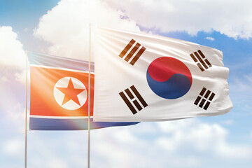 Sunny blue sky and flags of south korea and north korea