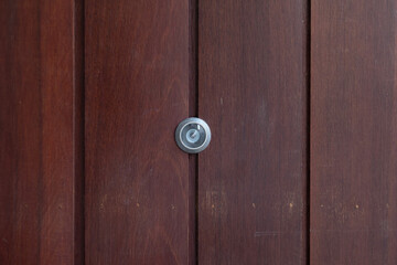 closeup eye door on grey wood background, peephole