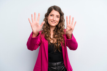 young adult pretty woman smiling and looking friendly, showing number nine or ninth with hand...