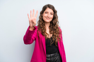 young adult pretty woman smiling and looking friendly, showing number four or fourth with hand...