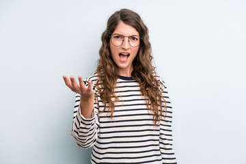 young adult pretty woman looking angry, annoyed and frustrated screaming wtf or what’s wrong with...