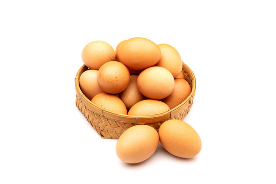 Chicken Eggs in basket isolated on white