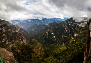 panoramic of copper canyon with a lot of green mountains and cloudy sky before rainning in chihuahua 