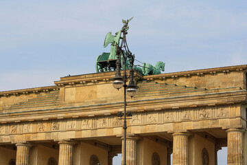 Quadriga bronze statue on top of Brandenburg gate or Brandenburger Tor in summer with clear blue sky background. No people.