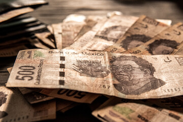 Naklejka premium Money piled on a table, mexican peso currency