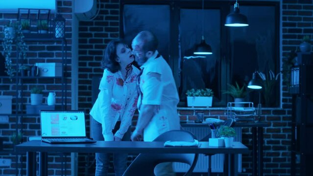 Crippled creepy zombies with bloody scars wandering around office at night. Mindless brain-eating evil looking monsters with deep wounds roaming around agency workspace while growling.