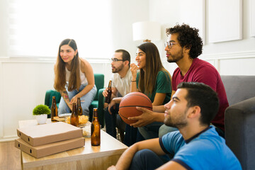 Sports fans hanging out to watch the basketball game