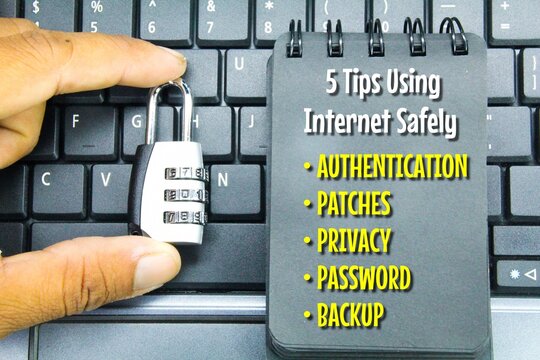 keys and notes with the words five Tips Using Internet Safely. Safety connection