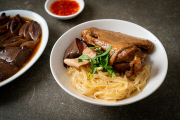 dried noodles with braised duck in white bowl