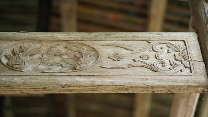 The old wooden Chinese architecture with the wood sculpture on the columns