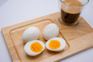Boiled Egg And Cup Black Coffee On Wooden Tray.