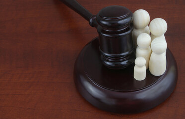 Family law and court concept. Judge gavel with family wooden people figure. Copy space for text.