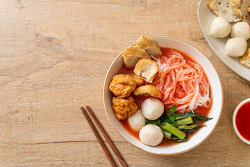 Obraz na płótnie Canvas small flat rice noodles with fish balls and shrimp balls in pink soup, Yen Ta Four or Yen Ta Fo
