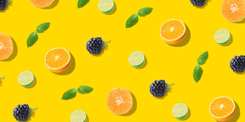 Citrus fruits, berries and mint on yellow background. Pattern for design