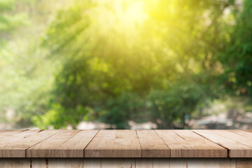 Wooden table and blurred green nature garden background with copy space