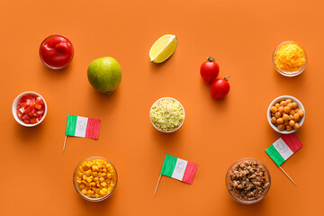 Composition with Mexican traditional food and flags on orange background