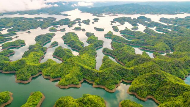 Time lapse Ta Dung lake seen from above in the morning with small islands of paradise with beautiful abstract shapes. This is the reservoir for increase in Dac Nong, Vietnam.