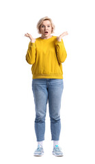 Shocked blonde woman in yellow sweatshirt on white background