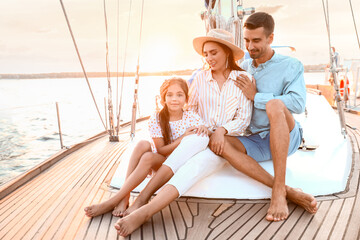 Fototapeta na wymiar Happy young family resting on yacht