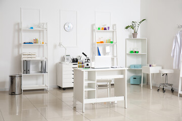 Interior of medical laboratory with modern workplace, microscope and laptop