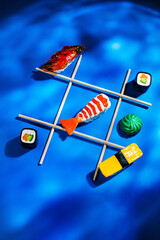 Asian food, sushi underwater, tic-tac-toe with chopsticks - 512247368