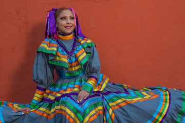 Portrait of a Mexican woman wearing a traditional dress for folk dance